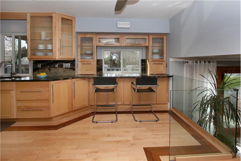 View of breakfast bar and frameless glass railing