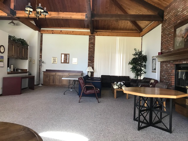 Interior of clubhouse, showing catering kitchen at left and fireplace at right