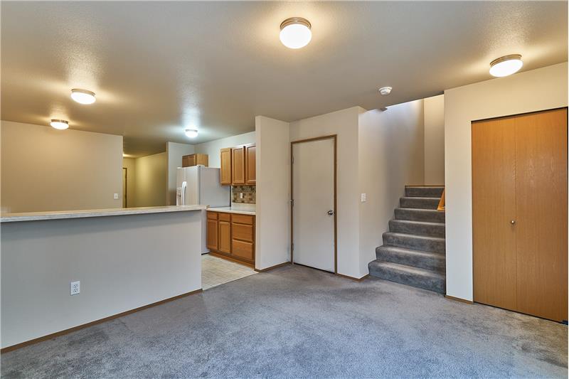 Large Dining Room off of the Kitchen with Stairs leading you upstairs.