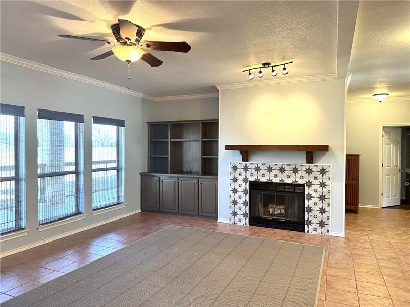 Large living room with lots of natural light overlooking back patio and golf course