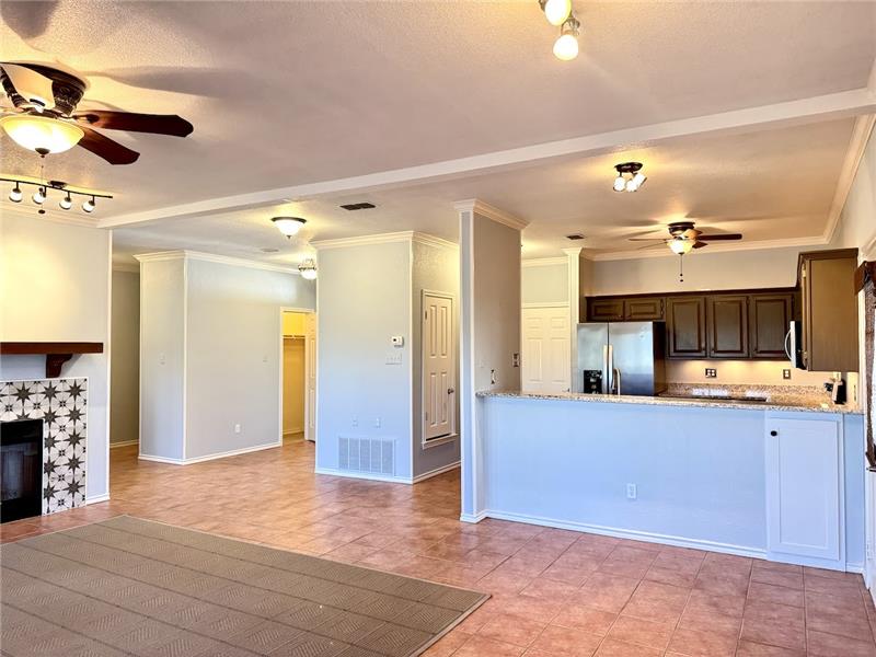 Kitchen features breakfast bar that opens to living room 