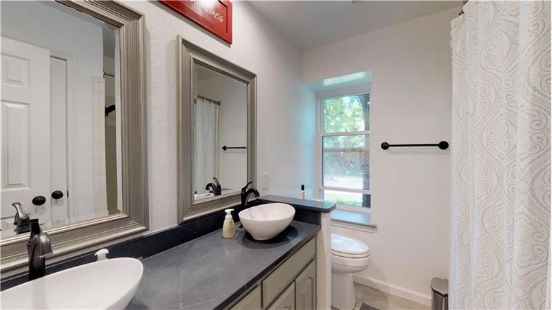 Secondary bathroom features bowl sinks, Quartz soapstone counters