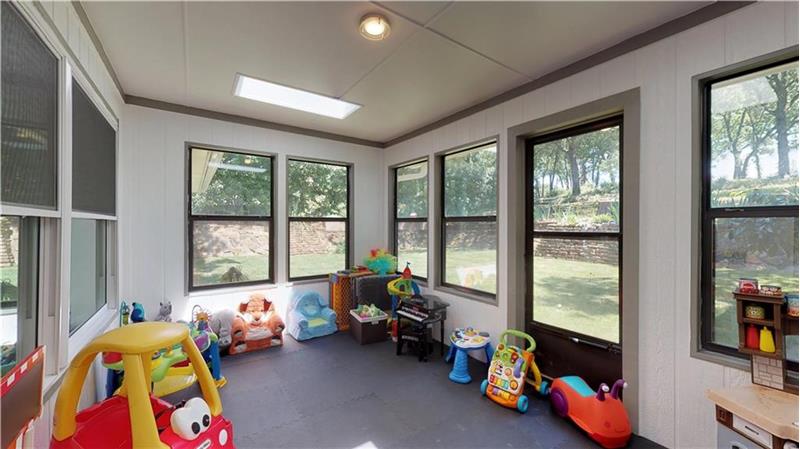 Enclosed sunroom can be a perfect game room or fitness space