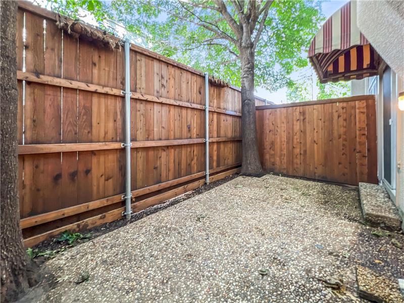 Private patio with large shade trees