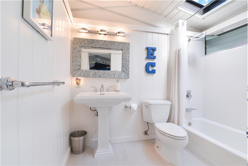 2nd Room Bathroom with Tub/Shower Combo, pedestal vanity sink, its very own Skylight and tremendous storage above.