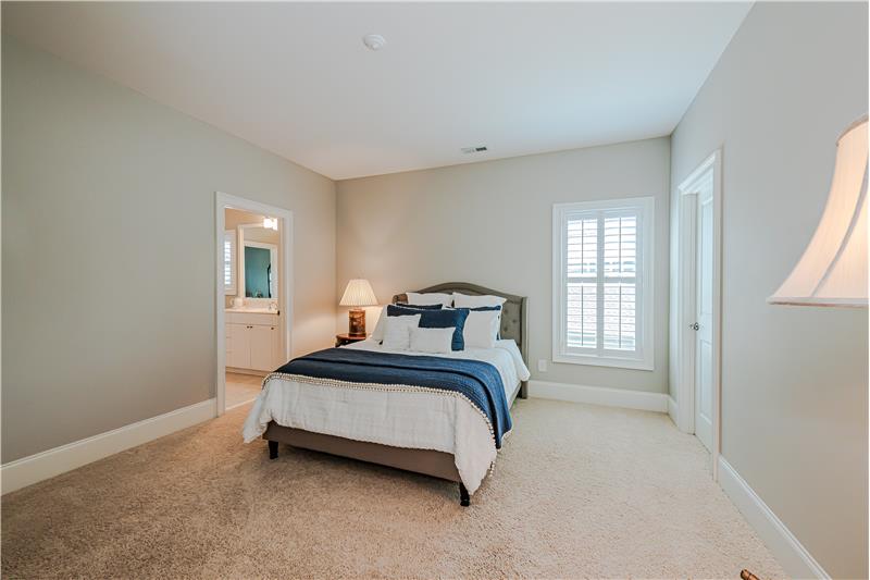 Secondary bedroom with walk-in closet, neutral decor. Direct access to Jack & Jill bathroom.