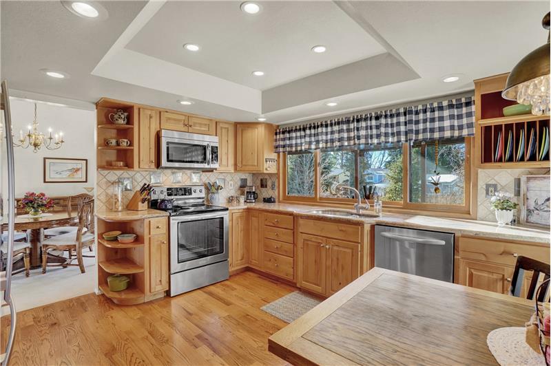 The Kitchen has wood floors, knotty alder cabinets with pull out drawers, granite countertops, and a pantry