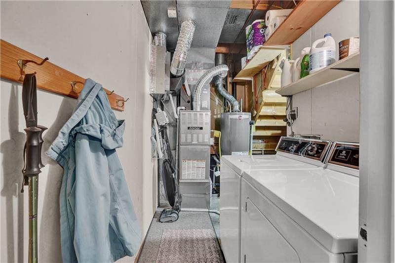 Lower level Laundry Room with newer water heater, furnace, and crawl space storage