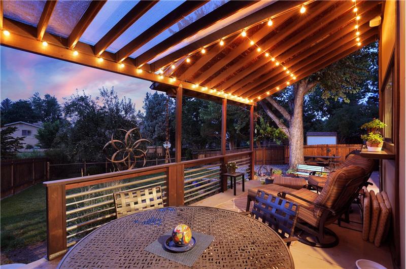Sunset View of backyard from the raised patio with lighted pergola