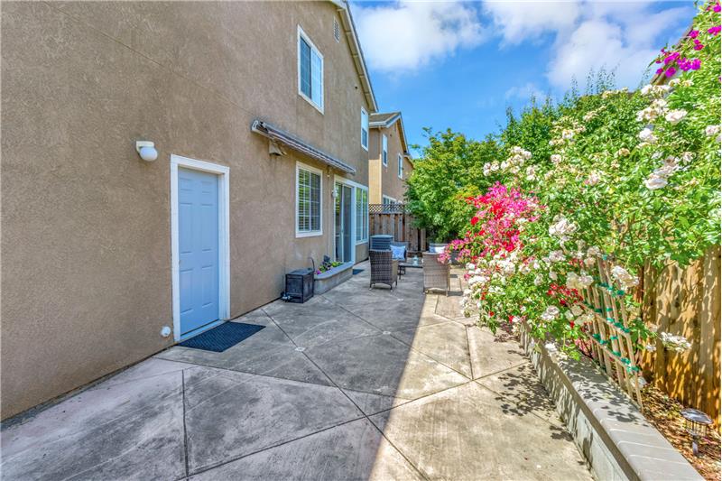 Flower-filled Backyard with Retractable Awning for Shade!