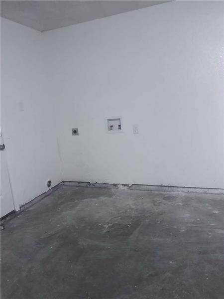 Laundry area featuring unfinished concrete flooring, hookup for a washing machine, and hookup for an electric dryer