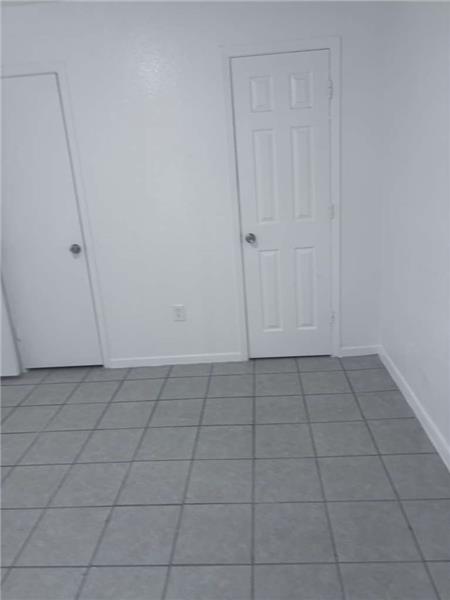 Tiled spare room with baseboards