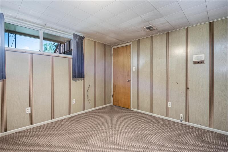 Both basement bedrooms feature attractive faux-wood paneling.