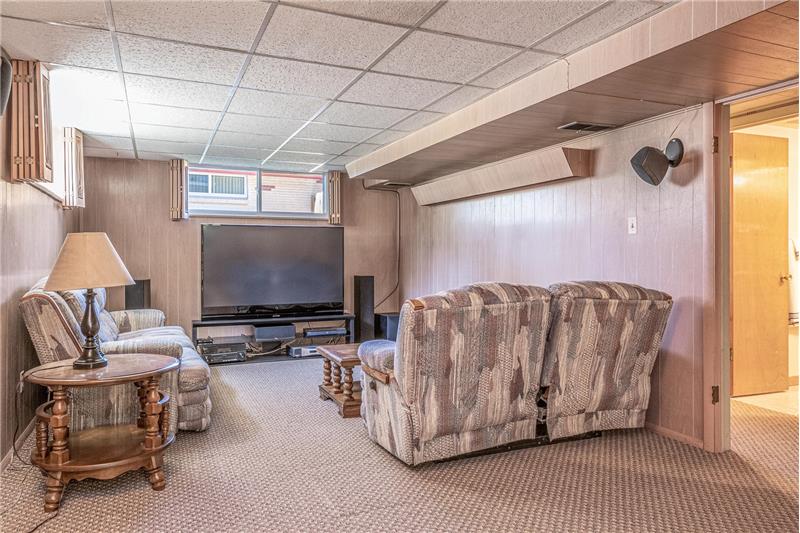 The 33-foot-long family room features a home theater with 7-speaker surround sound system (included) at this end.
