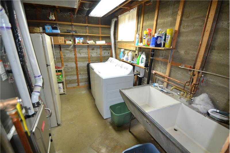 This laundry room is under the eat-in kitchen. Washer & dryer are included. Note the newer high efficiency furnace at left.