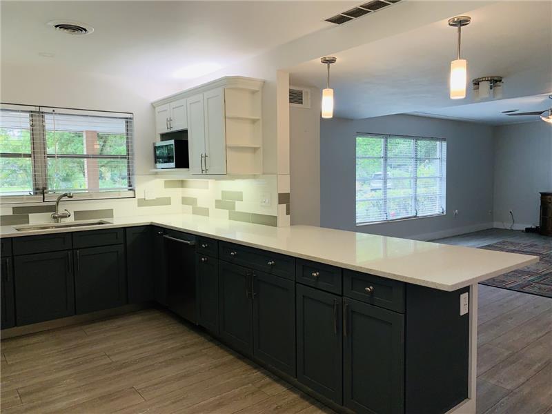Kitchen opens to Living and Dining Rooms