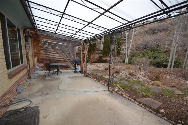 Covered patio with pergola beyond
