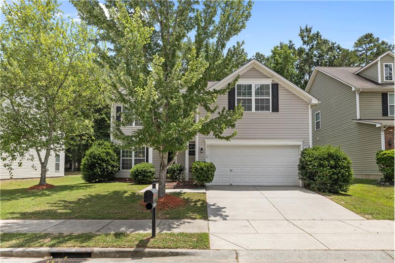 2-car garage with room for storage and space to park in driveway