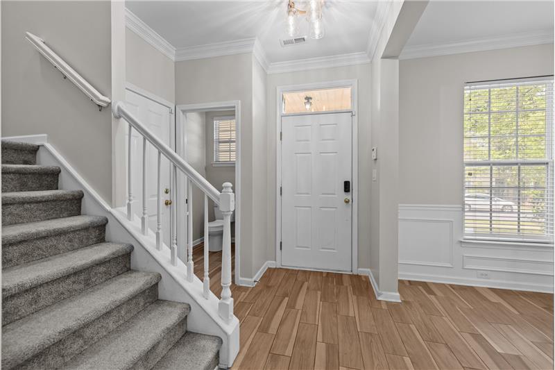 Interior entrance to home--dining room to the left, half bath to the right