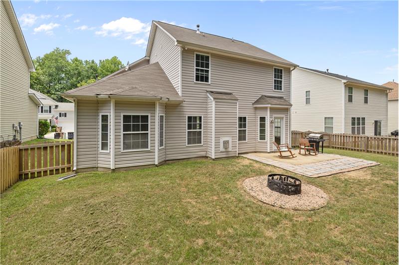 Cozy fire pit in the backyard creates the perfect spot for relaxing and enjoying cool evenings with family and friends