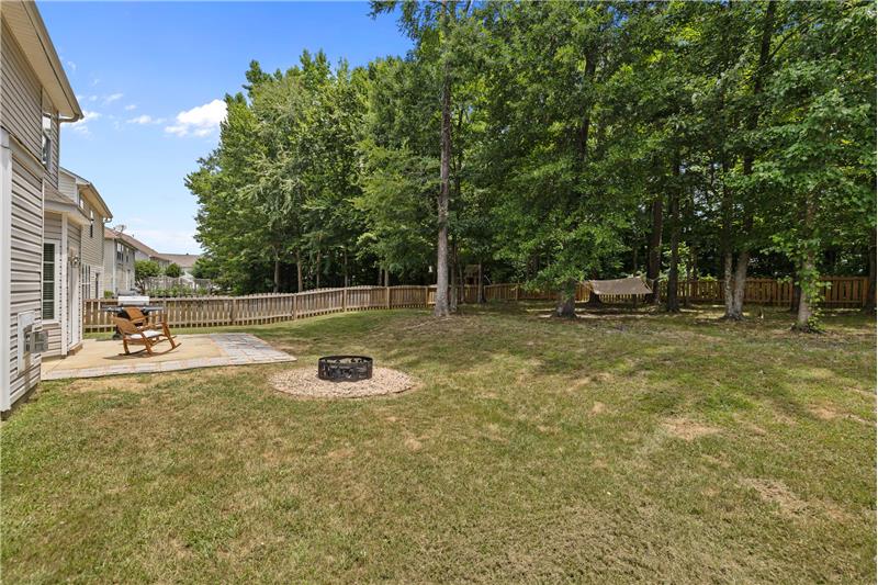 Property backs up to mature trees, offering a natural backdrop that enhances privacy