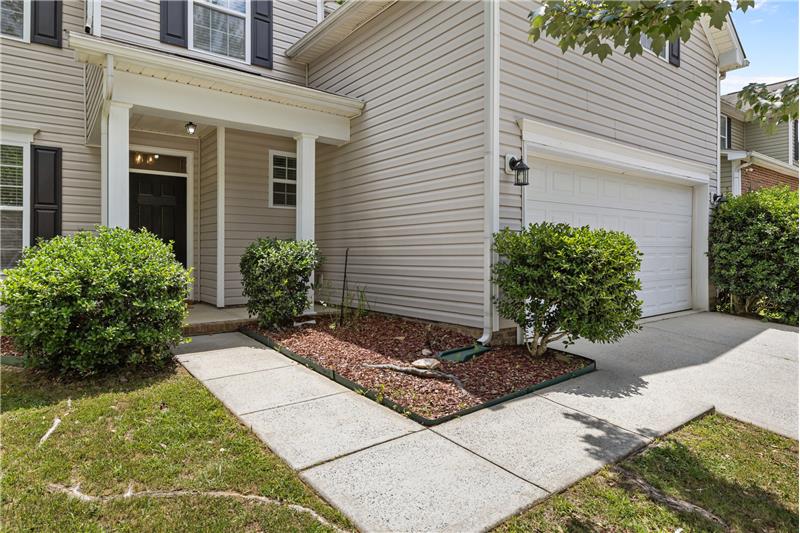 Attractive walk-way leads to covered front entrance, creating a welcoming entrance to the home