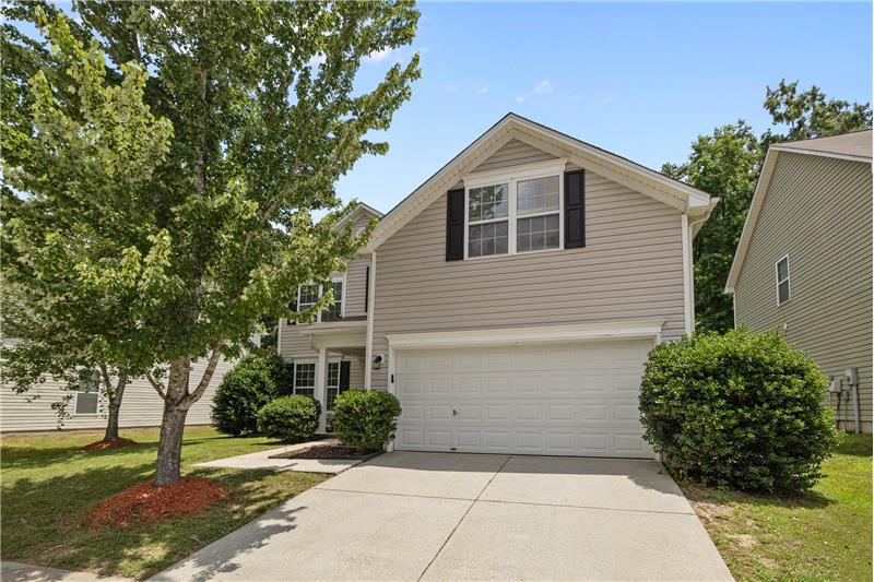 2-car garage with room for storage, along with a driveway that offers additional parking for guests or extra vehicles