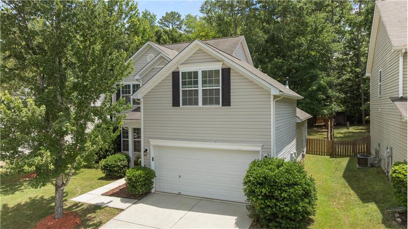 Home is set against a serene backdrop of mature trees, creating a peaceful setting and a sense of natural privacy