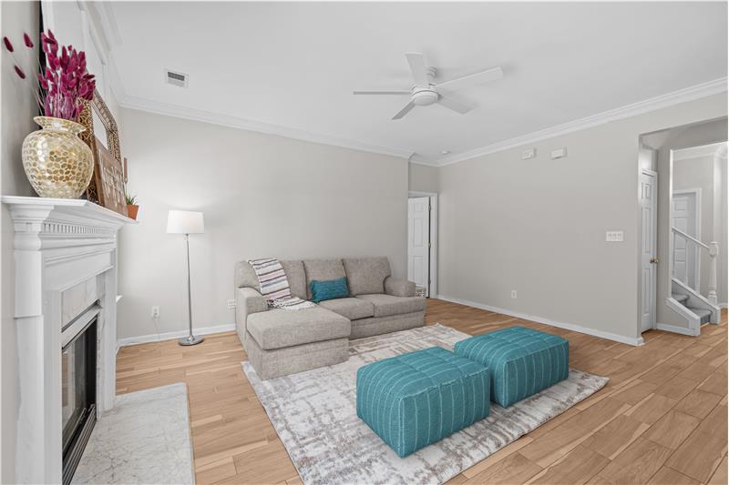 Just painted living room with crown molding, ceiling fan with light