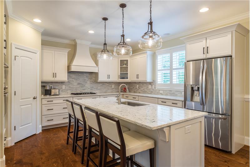 Updated Kitchen with classic white shaker cabinets and quartz
