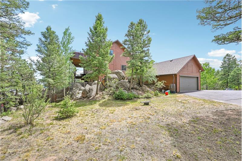 Backyard, showing side garage-like storage shed and RV or guest parking