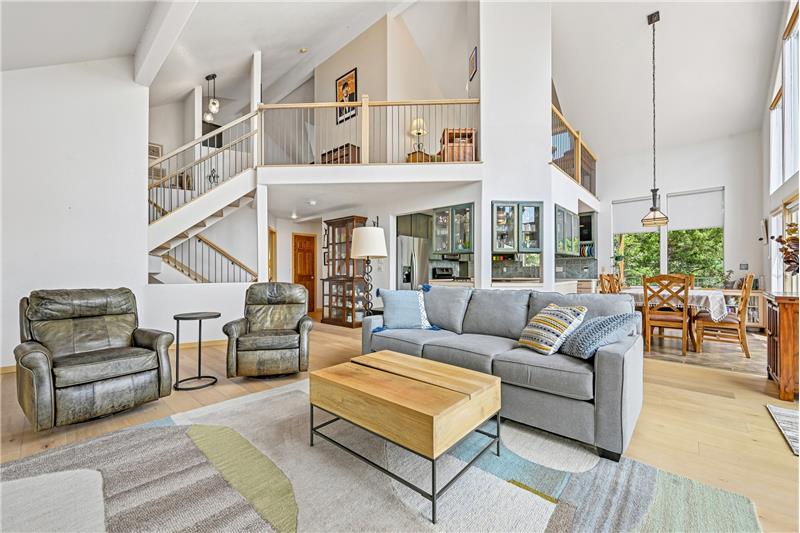 Great room, showing dining room at right and loft above