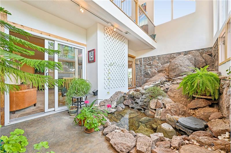 Water feature visible from foyer and lower level