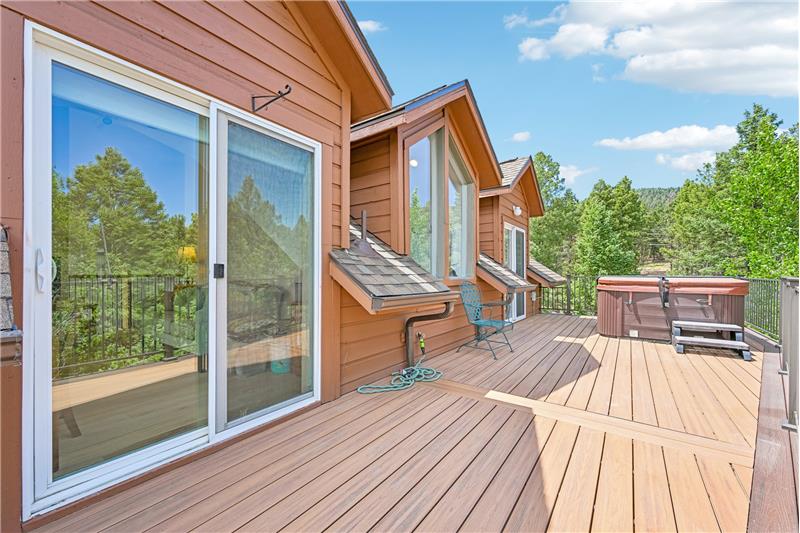 Deck with hot tub outside primary suite