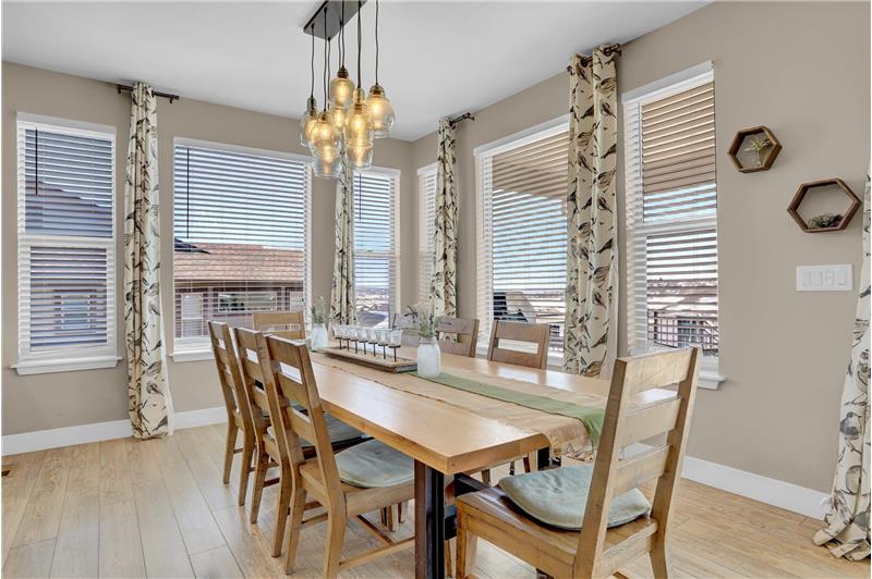 The Dining Area is surrounded with windows and features upgraded lighting