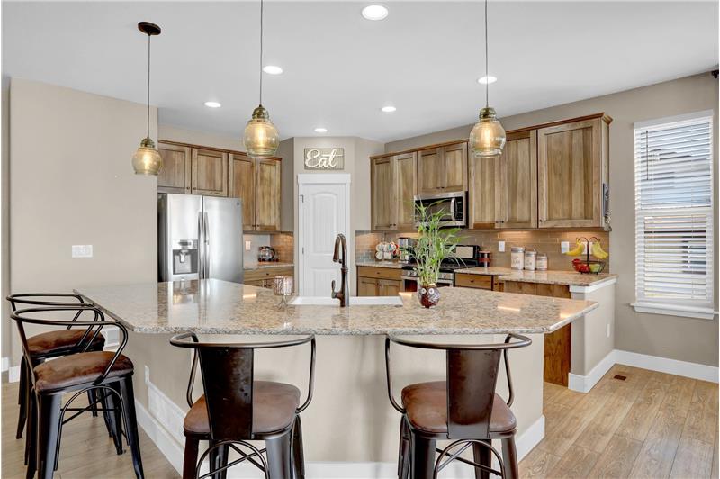 Island Kitchen wtih granite counter bar and upgraded pendant lights