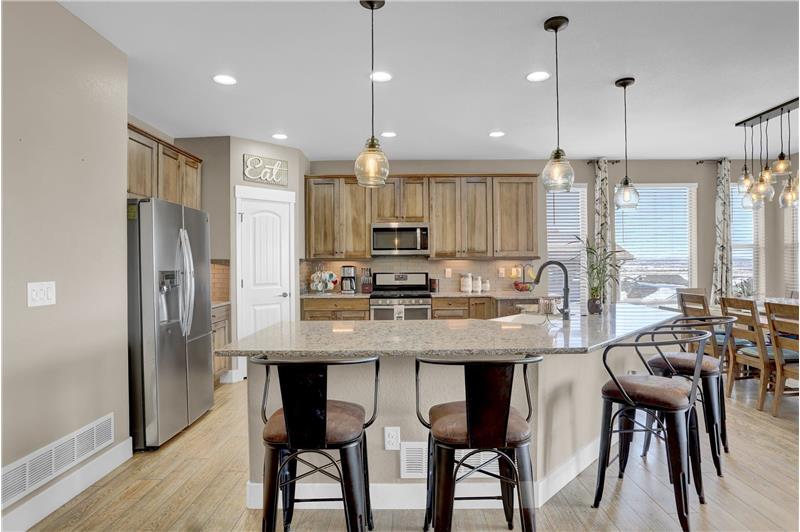 The Island Kitchen offers a pantry, attractive cabinetry w/granite countertops, a subway tile backsplash, upgraded pendant light