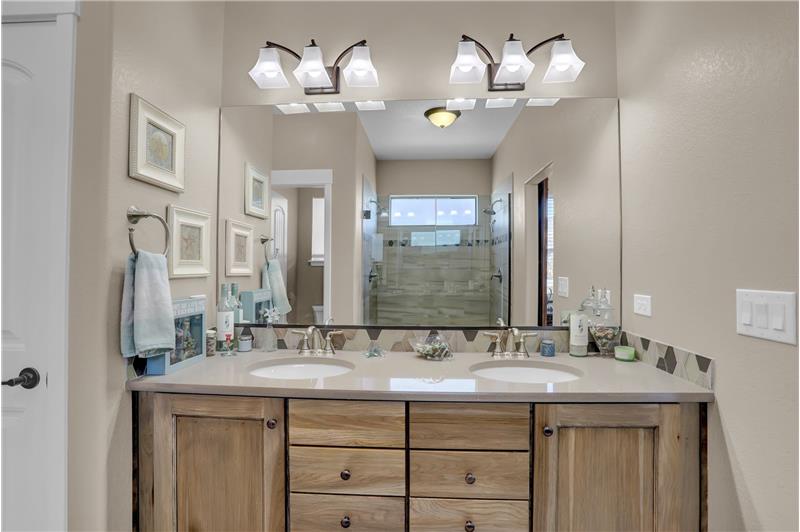 Primary Bathroom with dual sink vanity with quartz countertop and undermount sinks