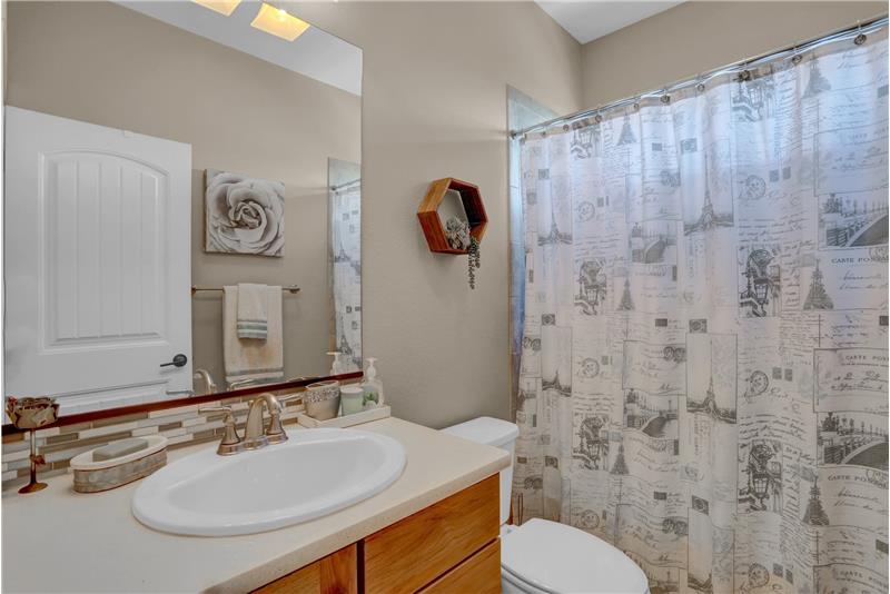 Main Level Hall Bathroom with vanity, mirror, tub/shower