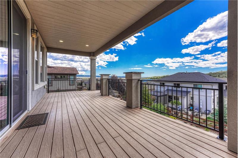 Sunset views from the covered composite deck with recessed lights and iron rails