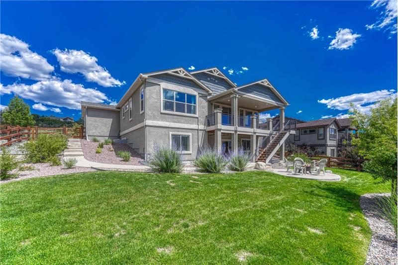Rear view of home and fenced backyard