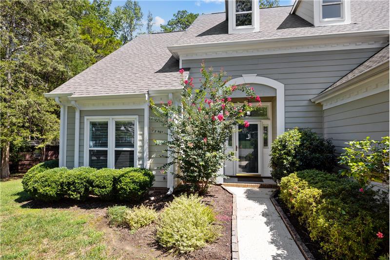 Lush landscaping + covered entry