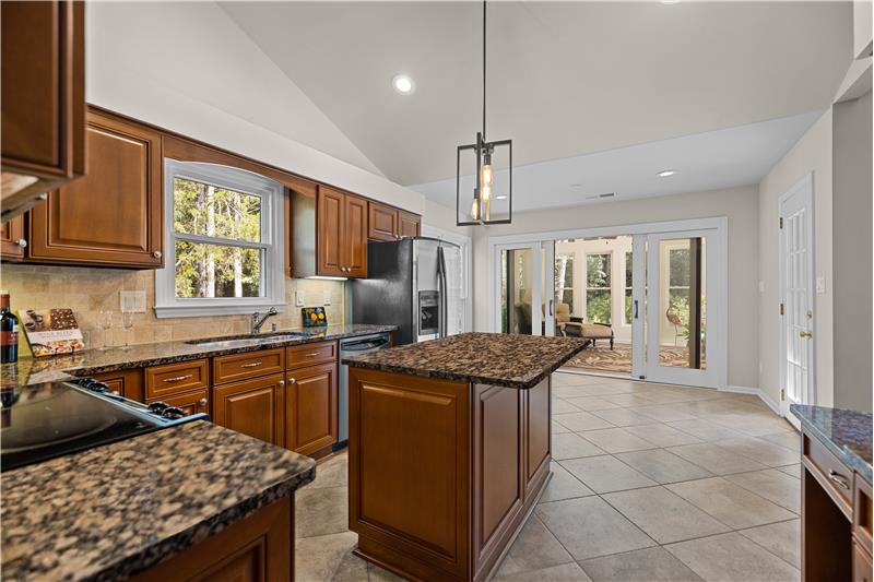 Kitchen with island and vaulted ceiling