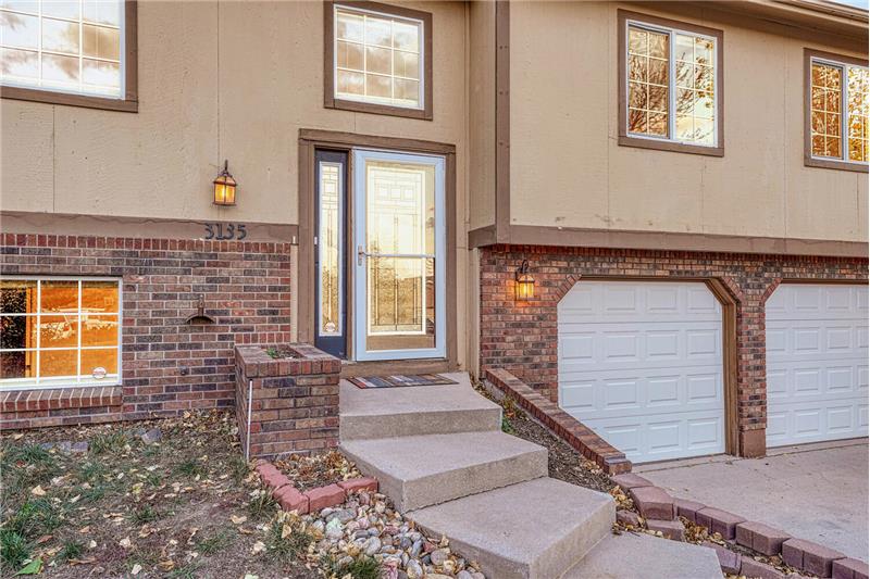 Attractive front door with lead glass insert and storm door