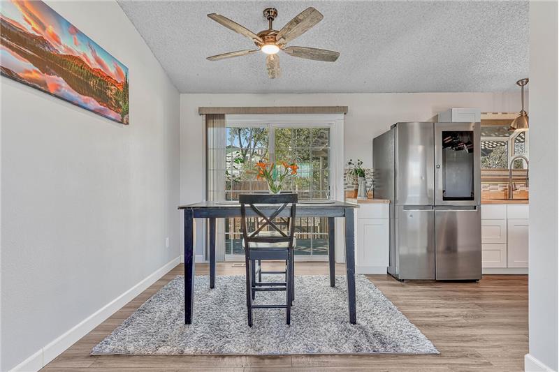 . The Dining Area includes a lighted ceiling fan and a slider to the backyard deck