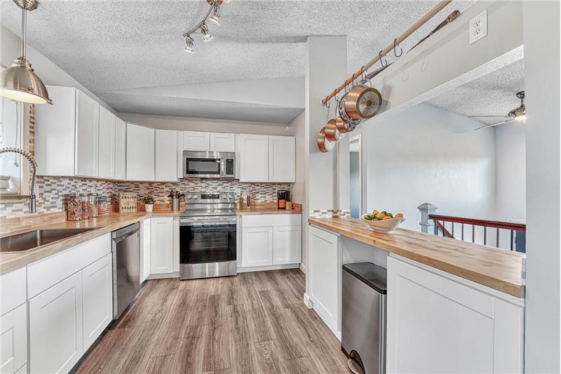 Updated Kitchen with track & pendant lighting and a garden window