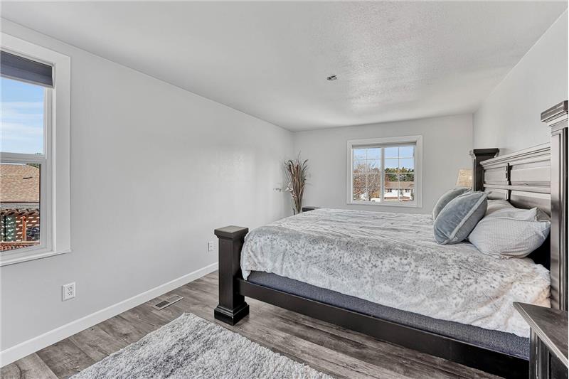 The upper level Primary Bedroom has cellular shades and a walk-in closet