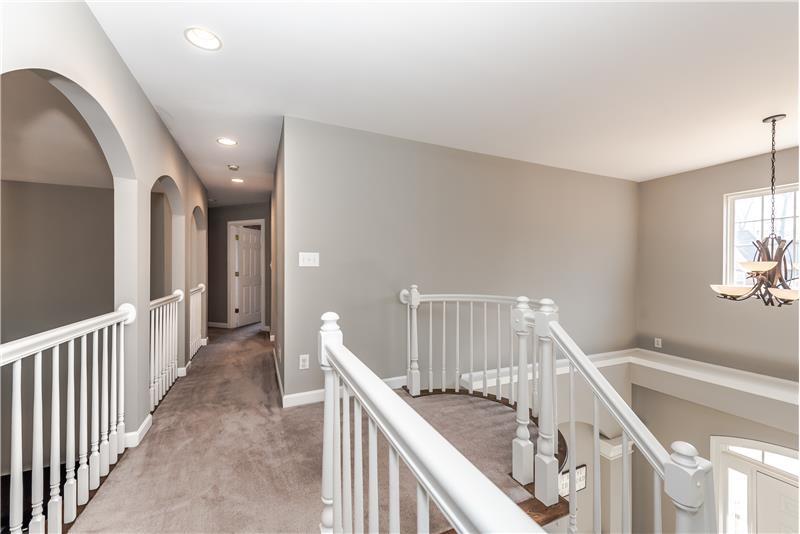 Second floor landing/cat walk with lovely architectural details and Juliette balcony overlooks great room and foyer.