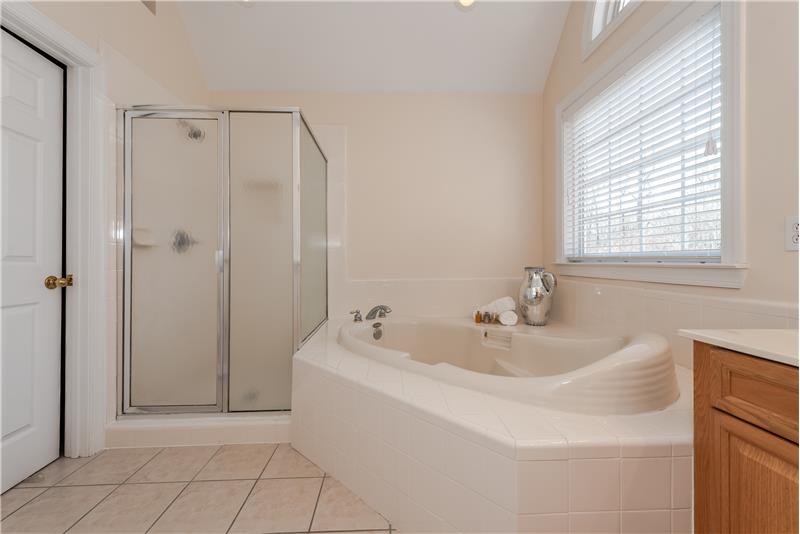 Separate shower plus a deep soaking tub. Large window with Palladian accent provides an abundance of natural light.