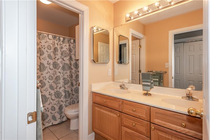 Shared hall bathroom on second floor of home features a double-sink vanity.